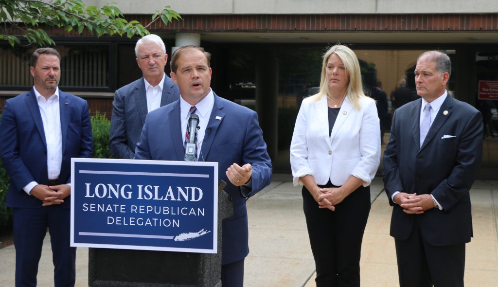 Ray Tierney (standing behind podium), Candidate for Suffolk County District Attorney, addresses the rise in violent crime in Suffolk County during a press conference in front of Suffolk County District Court in Patchogue on July 29. Also pictured (left to right): Rob Ortt, Minority Leader, New York State Senate; and Phil Boyle, Alexis Weik and Mario Mattera, New York State Senators.
